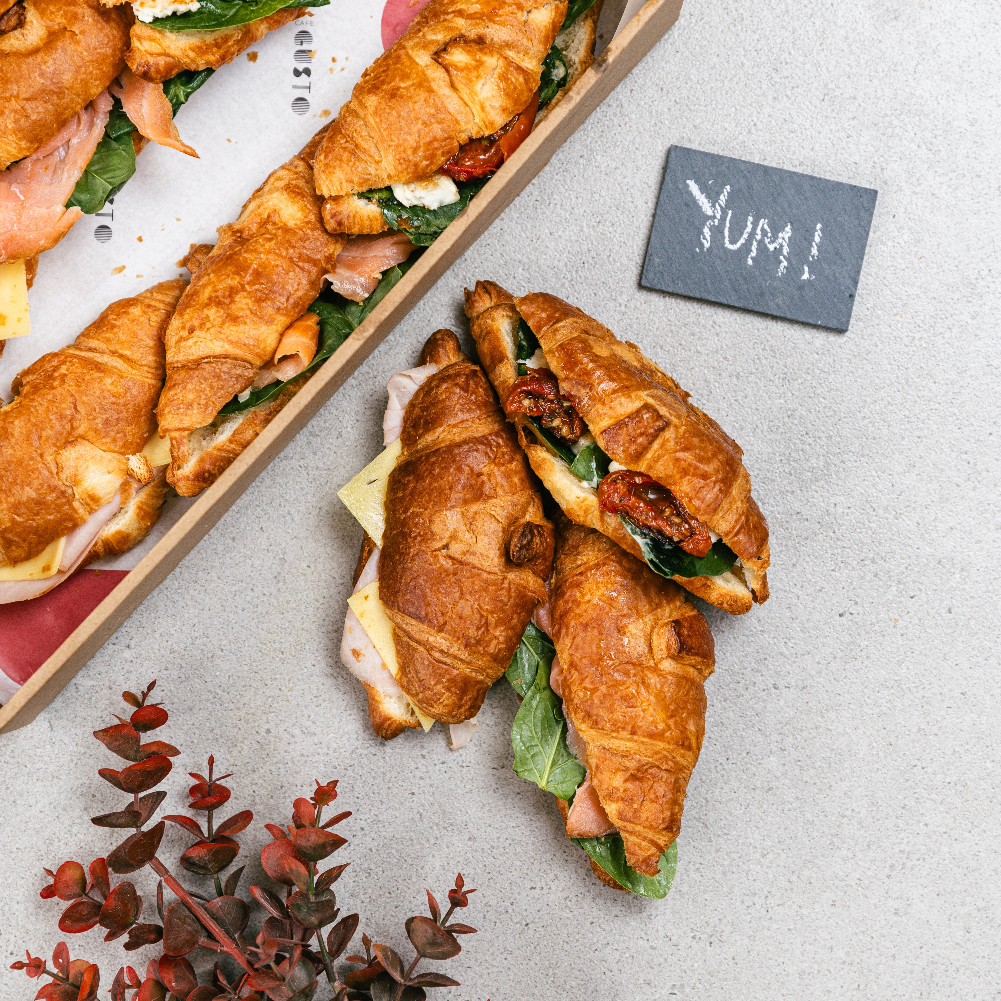 Mini Croissants filled with smoked salmon and whipped ricotta, Smoked leg ham and cheese, semi dried tomatoes, fetta cheese and aby spinach. Boxed for catering services Sydney